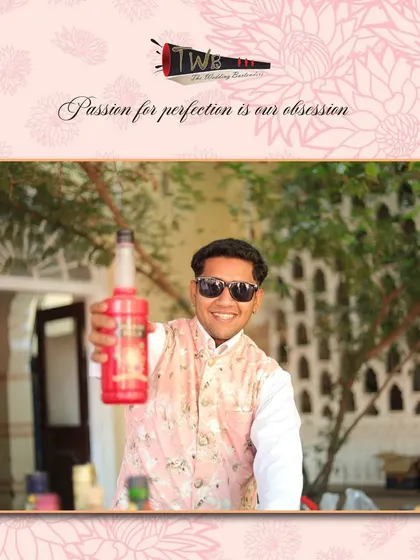 Our bartender showcasing a bottle of premium syrup, a key ingredient in many of our unique and flavorful cocktail creations.