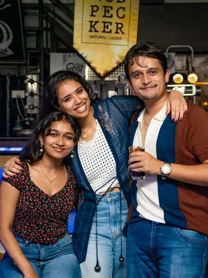 A stylish trio posing for a photo. My pub's ambiance is great for capturing those cool, memorable shots with friends.