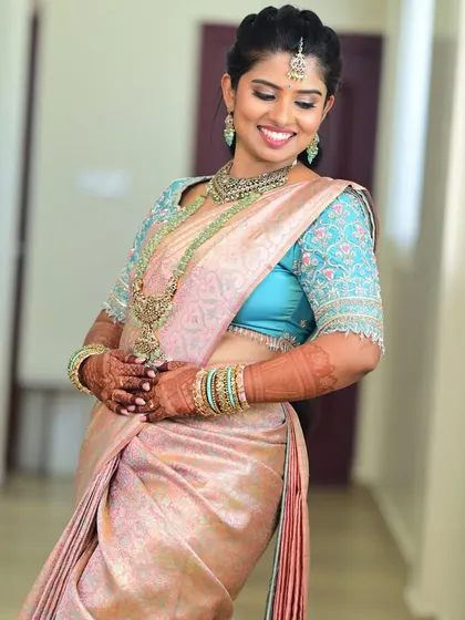 The bride's smile says it all. She looks comfortable and beautiful in her custom-fitted and designed blouse.