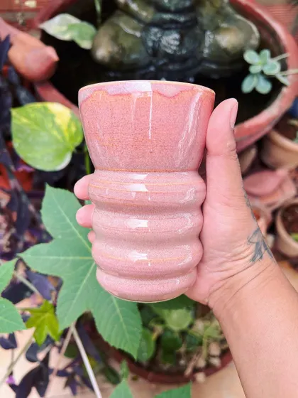 A ribbed pink tumbler, fresh from the kiln. The glaze has a beautiful speckled effect that I love.