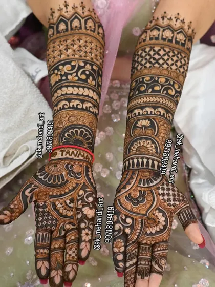 This bridal design features bold, symmetrical patterns with a focus on traditional bands and motifs, including the bride's name 'Tanmay' hidden within the design.