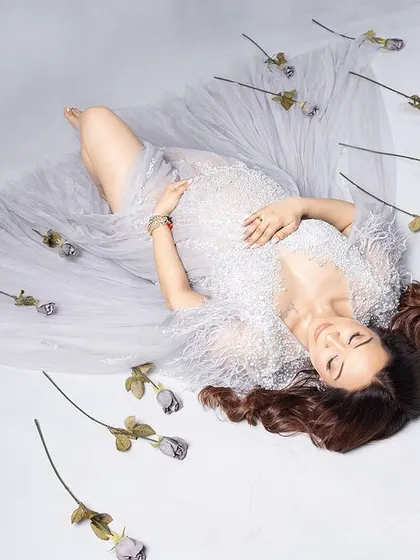 Simplicity is key. This artistic, top-down shot with a sheer white drape and scattered roses is beautifully minimalist and serene.