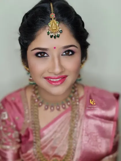 A stunning portrait of my repeat client Deepthi, her eyes sparkling and her smile bright, showing off her festive makeup.