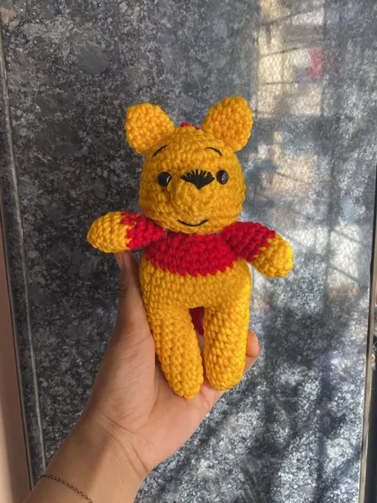 Everyone's favorite bear, Winnie the Pooh. This is a classic amigurumi doll, perfect for anyone who loves the character. I can make him in different sizes, from a small keychain to a larger plushie.
