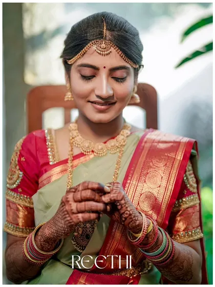 A beautiful close-up of the bride, her gentle smile and intricate henna on display.