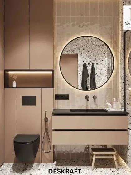 The vanity area features a circular backlit mirror, a sleek black sink, and beige cabinetry, creating a warm and modern space. The black toilet adds a bold, contrasting element.