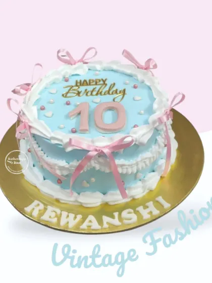 A sweet blue and pink vintage cake for a 10th birthday. The design is adorned with delicate pink ribbons and heart sprinkles.