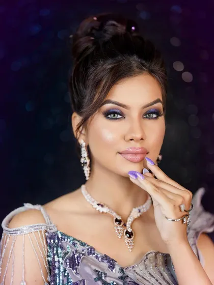 A bold and glamorous look perfect for a cocktail party or reception. The model wears a stunning diamond and sapphire set against a sequined gown, with dramatic smokey eye makeup.