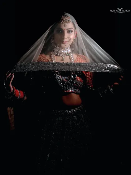 A variation of the veil shot, with the bride peeking at the camera. This adds a touch of playfulness to the otherwise dramatic and high-fashion portrait.