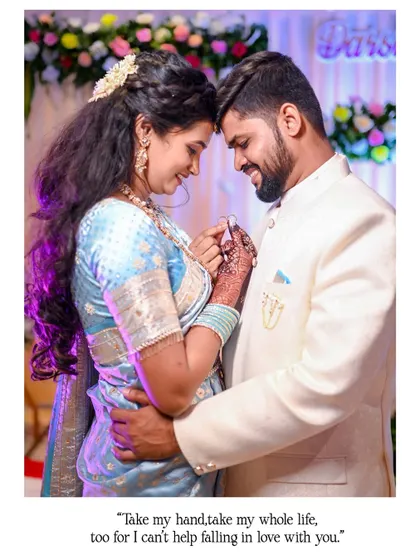 A beautiful portrait of the couple holding their rings. The groom embraces the bride as they both look at the ring, capturing a moment of shared happiness and love.