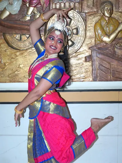 A playful and energetic pose that captures the dynamic nature of the dance performance.