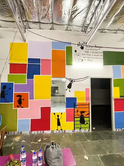 A work-in-progress shot of the Dharavi school mural, with me standing back to take in the scale of the transformation.