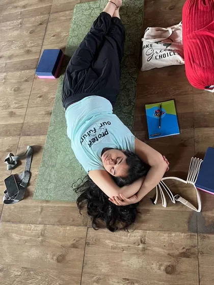 Find your stillness and embrace the quiet within. A student rests peacefully during a Yin yoga class.
