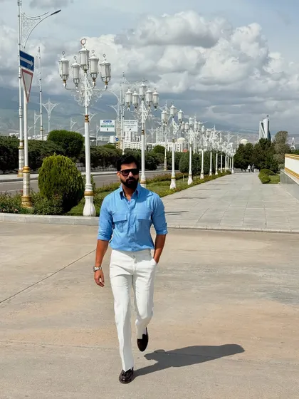 A walking shot that showcases the full outfit, demonstrating a confident and polished look perfect for a day of sightseeing.