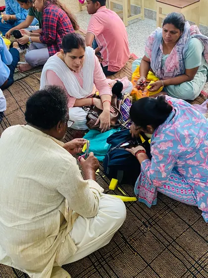 I always sit with my students to help them directly. Here, I am showing a group of teachers the technique for making a simple hand puppet.