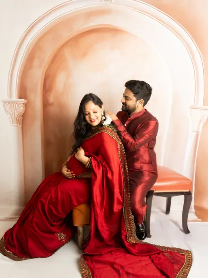 A romantic pose during a traditional shoot. The husband-to-be placing a flower in his wife's hair is a gesture of love and admiration.