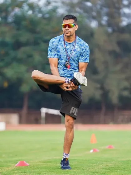 The process is everything. A moment of demonstration during a dynamic warm-up, focusing on hip mobility.