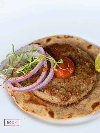 The textures of the soft kebab and the crisp taco, topped with fresh onions and microgreens, create a delightful bite. I love to play with contrasts in my dishes.