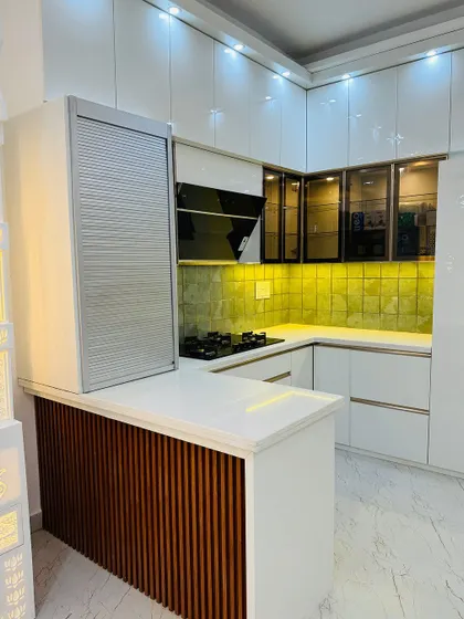 This image highlights the breakfast counter and rolling shutter unit, which helps keep small appliances neatly tucked away.