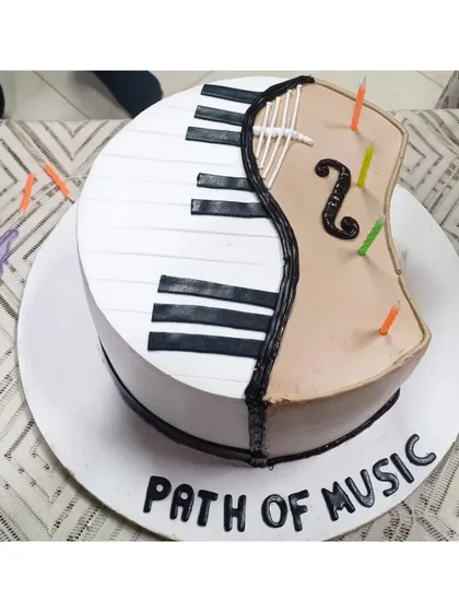 A custom cake designed for our Annual Fest, featuring a piano and a violin. This represents the fusion of different musical disciplines that we teach and celebrate at our college.