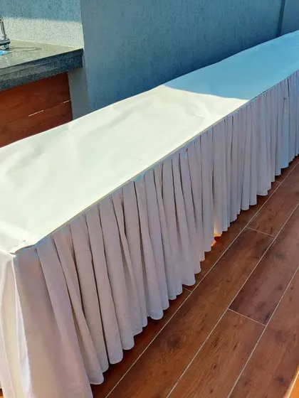 A clean and simple buffet table with a white skirt, which I provided for the rooftop party to serve food and drinks.