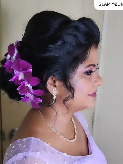 Beauty in every bloom. You can never go wrong accessorizing your hairstyle with fresh flowers, and these purple orchids add a timeless and vibrant touch to this messy bun.