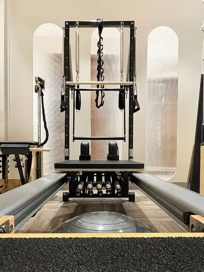 A close up of the Pilates Reformer. This versatile machine uses adjustable springs and a sliding carriage to facilitate a huge range of exercises.