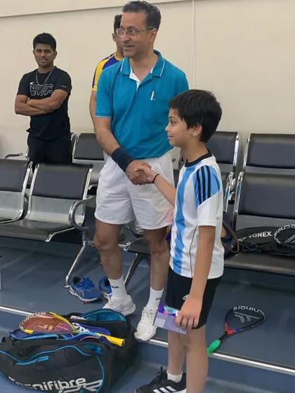 A moment of sportsmanship at the Willingdon Squash Academy tournament, as a young player receives his prize.
