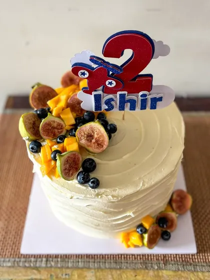 A different angle of the fresh fruit cake, showing the cascade of colorful fruit.
