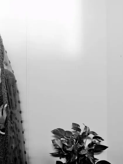 A timeless black and white bridal portrait. This style emphasizes the bride's expression and the classic beauty of her look, free from the distraction of color.
