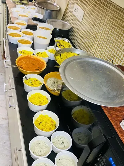 Another view of a large order being prepared for our tiffin service. We ensure every meal is packed fresh for delivery.