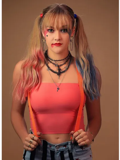 A classic Harley Quinn pose, capturing her playful yet unhinged personality. The styling, from the suspenders to the layered necklaces, is spot-on.