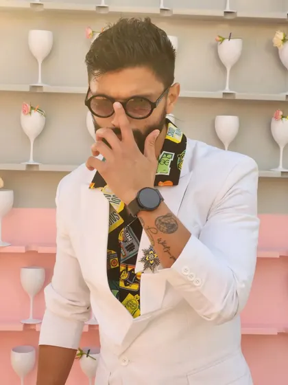 Another angle of the quirky white suit. It's all about the details, from the printed shirt to the brooch.