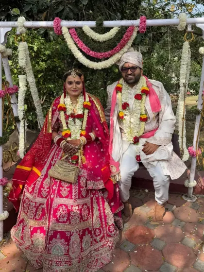 Harsh and Priyanka seated on a swing at their wedding, a picture of joy and celebration. Their love story is a beautiful blend of different professions and cities, united by spirituality.