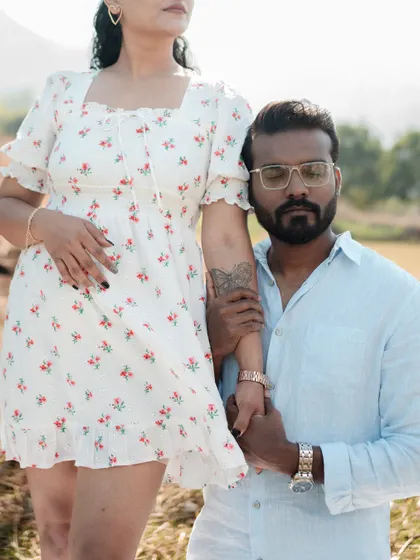 A modern and stylish pose of a couple in a natural setting. This close-up shot highlights their connection and fashion sense, blending contemporary style with an outdoor location.