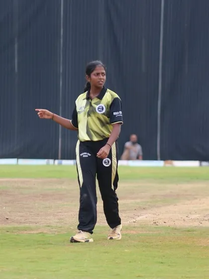 A young female player directing her fielders during a match.