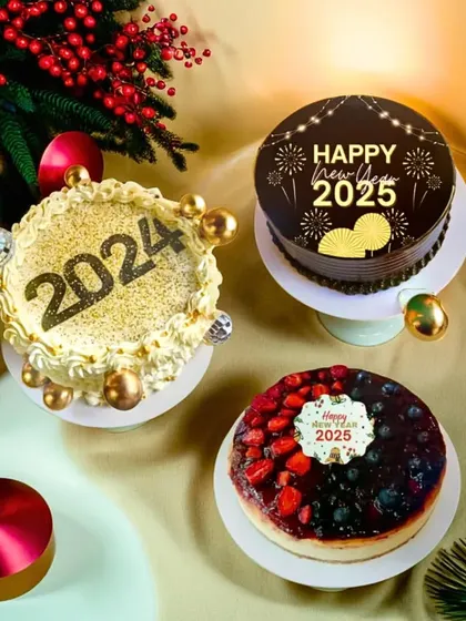 Ring in the New Year with our special collection of cakes. This image showcases our burn-away cake, a chocolate cake, and a berry cheesecake, all decorated for a 2025 celebration.
