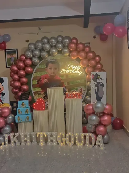 This view shows the "Happy Birthday" neon sign glowing behind the custom photo backdrop. I can create personalized backdrops for your child's special day.