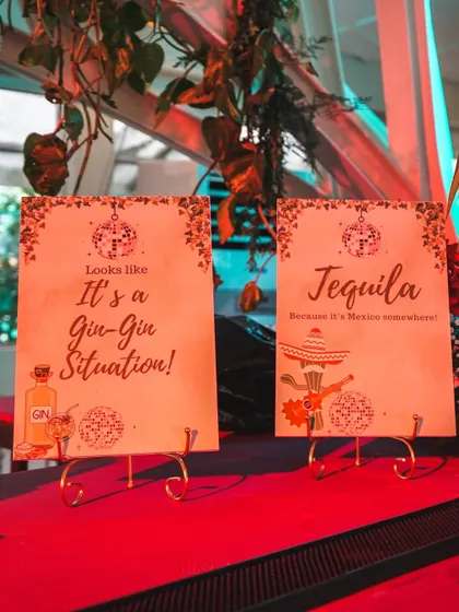 Fun, quirky bar signs for the 'Jungle Disco' reception. The playful text, "Looks like it's a Gin-Gin Situation!", adds a touch of humor and personality to the event.