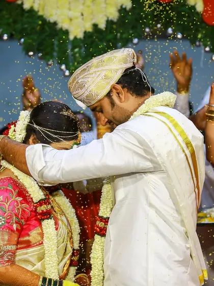 The joyous shower of blessings during a traditional South Indian wedding ceremony. We focus on capturing the energy and key rituals that make your wedding day unforgettable.