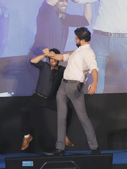 An interactive and physical routine with a volunteer on stage. These moments of playful struggle always get a huge laugh from the crowd.