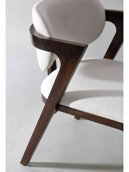 A detail of the mid-century armchair's wooden frame, showing the clean lines and expert joinery that define this iconic style.