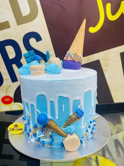 A cool blue 2kg ice cream-themed cake with a white chocolate drip and mini fondant cones.