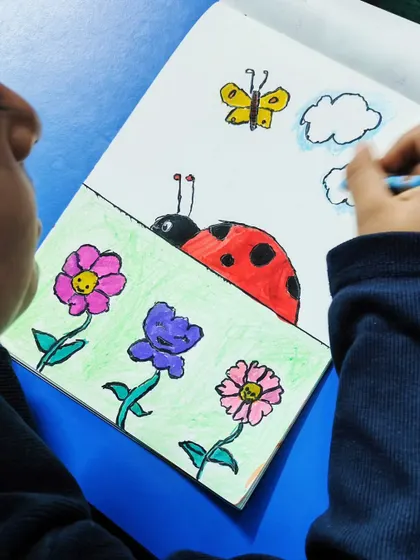 A close-up of the ladybug drawing in progress, showing how we build a picture with different elements.
