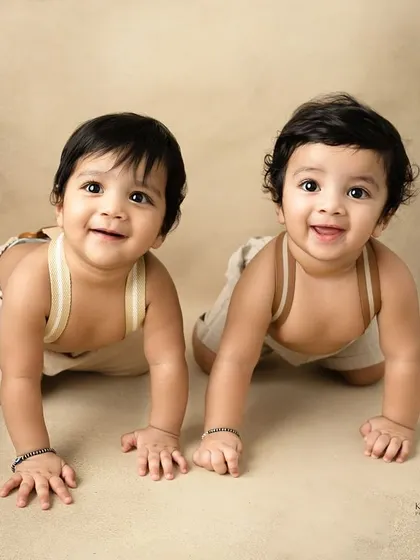 The most adorable twin brothers ever. At eight months old, their smiles are infectious, and capturing them together shows their developing bond.