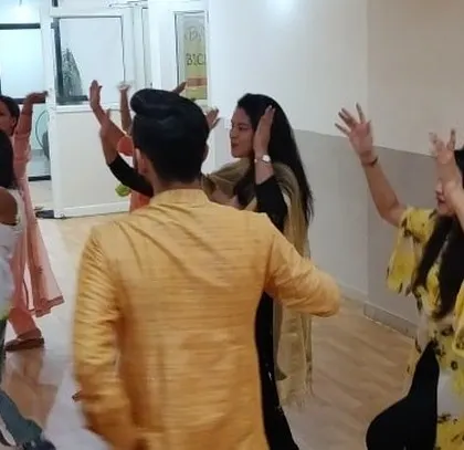 Instructors and students dancing together, showing the blend of culture and fitness at our Diwali event.