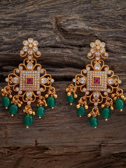 These square-shaped drop earrings feature a central ruby-colored stone surrounded by sparkling white stones. The design is finished with clusters of green beads, offering a classic color combination.
