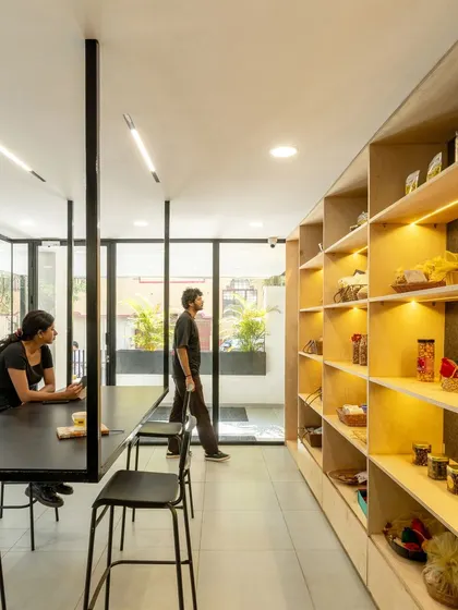 For 'Going Nuts', a healthy snack company, we designed a small retail space that creates a strong brand identity. Backlit wooden shelves showcase the products, while a long communal table invites customers to linger in the bright, light-filled interior.