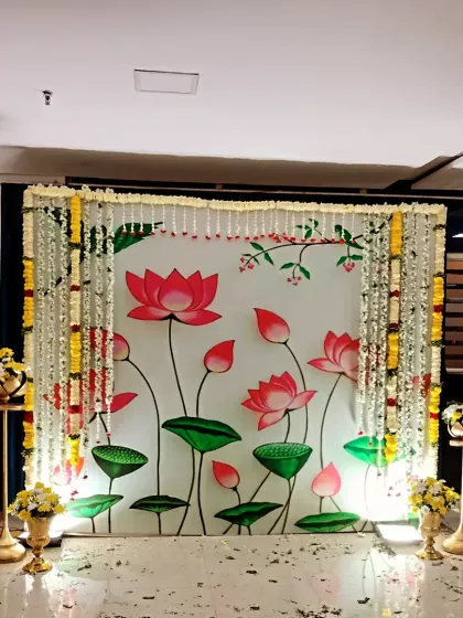 A charming lotus-themed backdrop for Pallavi's first birthday. This traditional design is adorned with fresh marigold and jasmine garlands for a divine and beautiful celebration.