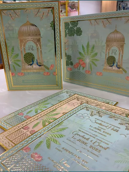 A closer view of the wedding invitation cards, showcasing the intricate gold foil work and the personalized details for the wedding events.